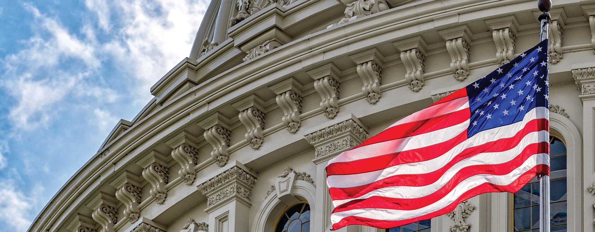 American flag flying in front of a government building